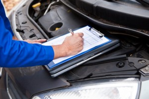 Mechanic Maintaining Car Records